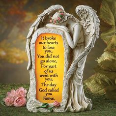 an angel figurine with a poem written on the side and flowers around it