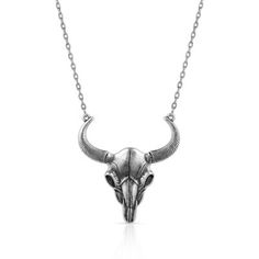 The Buffalo Skull Pendant Necklace is a bold accessory to add to any look. The sculpted pendant has a bright silver finish and depicts a buffalo skull in brilliant detail. The ends of the horns secure the pendant to a 21 inch silver tone adjustable chain to create the necklace. This piece adds a Southwest feel to any look! Montana Silversmiths necklaces are coated in Montana Armor to prevent tarnish. This necklace has a lobster clasp for ease of use. Feature a classic western motif with this sim Sterling Silver Skull Necklace For Gift, White Buffalo Necklace, Buffalo Necklace, Sterling Silver Skull Necklace, Black Skull-shaped Stainless Steel Necklace, Buffalo Skull, Skull Pendant Necklace, Bold Accessories, The Buffalo