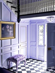 an entry way with a checkered floor and purple walls, painted in shades of lavender