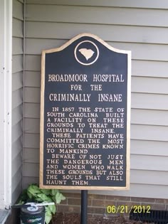 a sign on the side of a building that reads, broadmoor hospital for the criminally insane