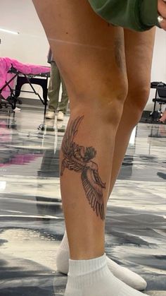 a person with a bird tattoo on their leg