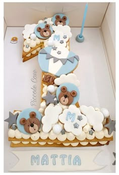 a cake in the shape of a letter with teddy bears and stars on it,