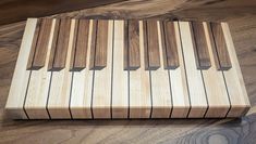 a close up of a piano on a wooden surface