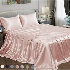 a bed covered in pink sheets and pillows