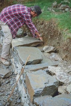 a man standing on top of a pile of rocks