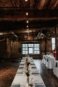 a long table is set up with white linens and flowers