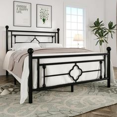 a black metal bed frame in a bedroom