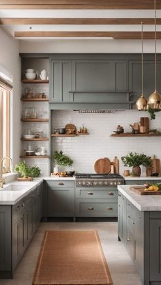 a kitchen with gray cabinets and white counter tops, an area rug on the floor