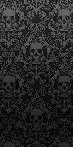 a black and white wallpaper with skulls on it's backgroung