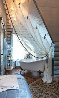 an old fashioned bathtub in the corner of a room with sheer curtains on it