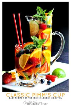 two glasses filled with water and fruit on a plate