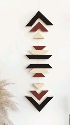 a wall hanging made out of wood with different shapes and colors on it's sides