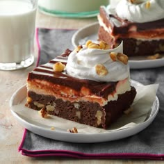 two pieces of cake sitting on top of plates next to a cup and glass of milk