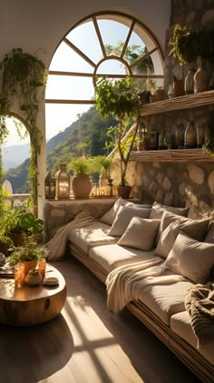 the sun shines through an arched window into a living room filled with furniture and potted plants