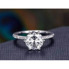 a diamond engagement ring on top of a table