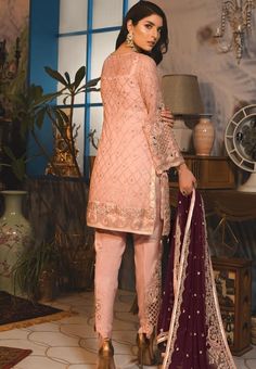 Designer Peach Dress With Intricate Embroidery, Peach Dress With Intricate Embroidery For High Fashion, Designer Peach Dress With Resham Embroidery, Peach Semi-stitched Dress For Designer Wear, Peach Tailored Dress For Designer Wear, Peach Dress With Intricate Embroidery For Eid, Elegant Red Dress With Mirror Work, Traditional Peach Dress With Resham Embroidery, Peach Dresses With Dabka Work For Eid