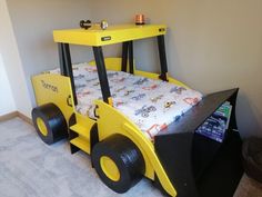 a child's bed made to look like a construction vehicle with wheels on it