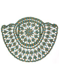 an intricately designed placemat with blue and green designs on the edges, against a white background