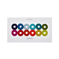 six different colored spools are arranged on a white card with the words wine o'clock