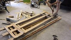 a man working on some wood in a garage