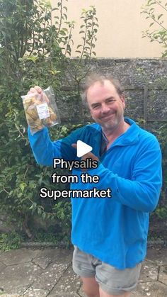 a man in blue jacket holding up a bag of food