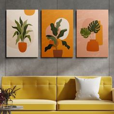 three paintings on the wall above a couch with a vase and potted plant in it