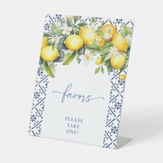 a greeting card with lemons and flowers on the front, in blue and white