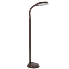 a brown floor lamp with a white light on it's side and a black base