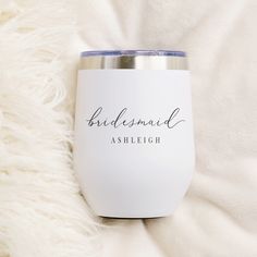 the bridesmaid stemless wine tumbler is sitting on a white blanket