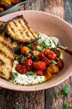 a bowl filled with food on top of a wooden table