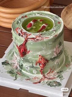 a green cake with red flowers on it