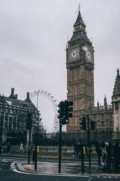 the big ben clock tower towering over the city of london on a gloomy day