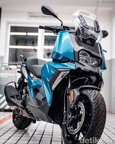 a blue motorcycle is parked in a garage