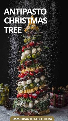 a christmas tree made out of fruits and vegetables with the words antipasto christmas tree