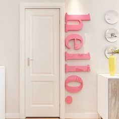 a white door with pink letters on the front and side of it in a room