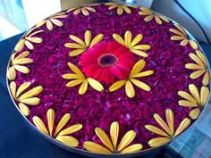 a cake decorated with yellow and red flowers