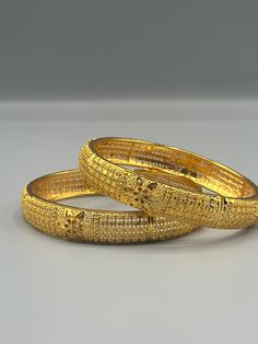 Our 24k Polished Bangles are more than just accessories; they are symbols of grace and beauty, inspired by the rich heritage of Indian, Pakistani, and Nepali jewelry. These stunning bangles showcase the timeless elegance of traditional craftsmanship, perfectly complementing your attire for weddings, festivals, or any special occasion Our company offers expedited Next-Day Delivery Services within the United Kingdom, ensuring prompt and efficient transportation of goods.  Additionally, we strive to extend our shipping capabilities to cater to customers worldwide, aiming to provide the fastest possible shipping methods to international destinations. To ensure the highest standards of hygiene, we kindly request your understanding that all sales are final, and we are unable to accept returns or Traditional Gold Jewelry For Anniversary, Gold Jewelry For Festivals And Anniversaries, Traditional Yellow Jewelry For Formal Occasions, Gold Jewelry For Festival Anniversaries, Gold Jewelry For Anniversary And Festivals, Gold Jewelry For Anniversaries And Festivals, Luxury Gold Jewelry For Festive Season, Traditional Yellow Formal Jewelry, Gold Intricate Design Bracelet Jewelry