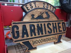 a wooden sign that says garnished woodworking on it's side in a shop