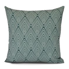 a green and white pillow on a white background