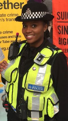 a woman police officer is smiling for the camera