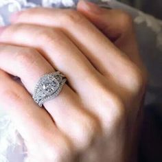 a woman's hand with a diamond ring on it