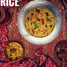 an image of rice in a bowl on a table with other dishes and utensils