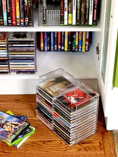 the dvd collection is stacked on top of each other in front of a bookshelf