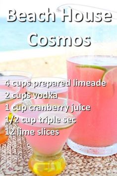 three glasses filled with drinks sitting on top of a table next to the ocean and beach