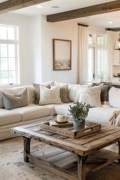 a living room filled with lots of furniture and pillows on top of a wooden table