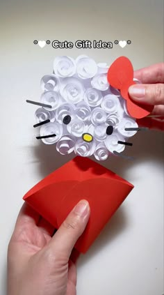 someone is making a kitty out of paper