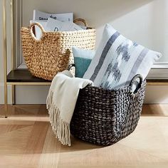 three baskets sitting on top of a wooden shelf