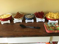 a table topped with bowls filled with different types of snacks and crackers on top of it