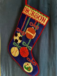 an embroidered christmas stocking with sports related items