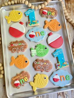 decorated cookies in the shape of fish on a tray